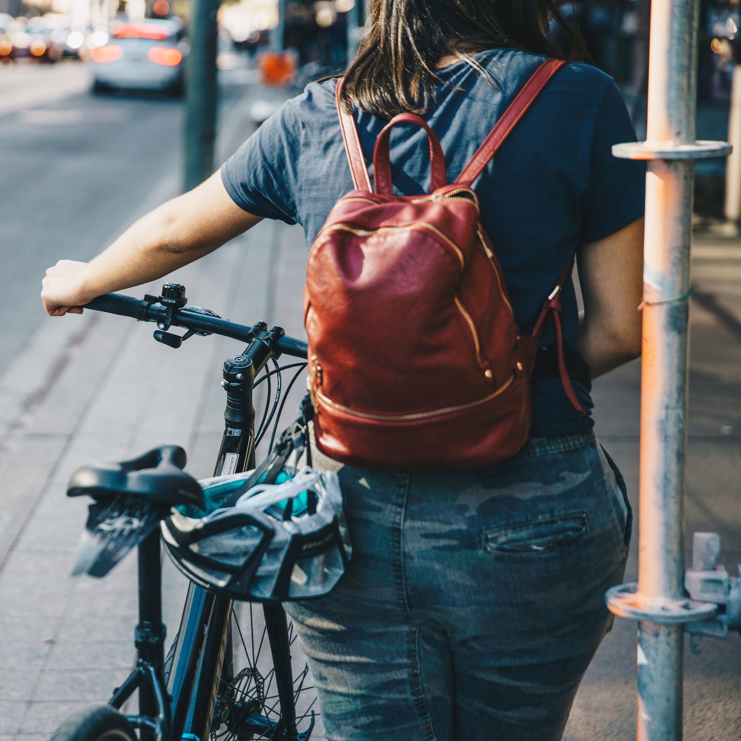 Country Carry Ya'lls at Gravel Chic, Young Woman with Bike and Leather Backpack