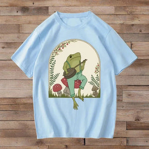 Banjo frog on mushroom design on light blue t-shirt