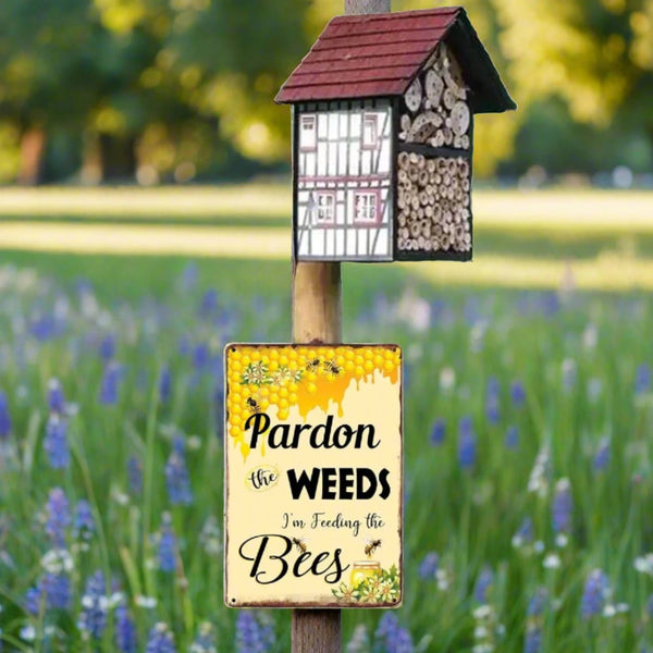 Pardon weeds feeding bees tin sign