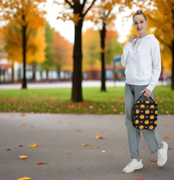 Pumpkin Boo insulated lunch bag carried by woman near a school in the fall